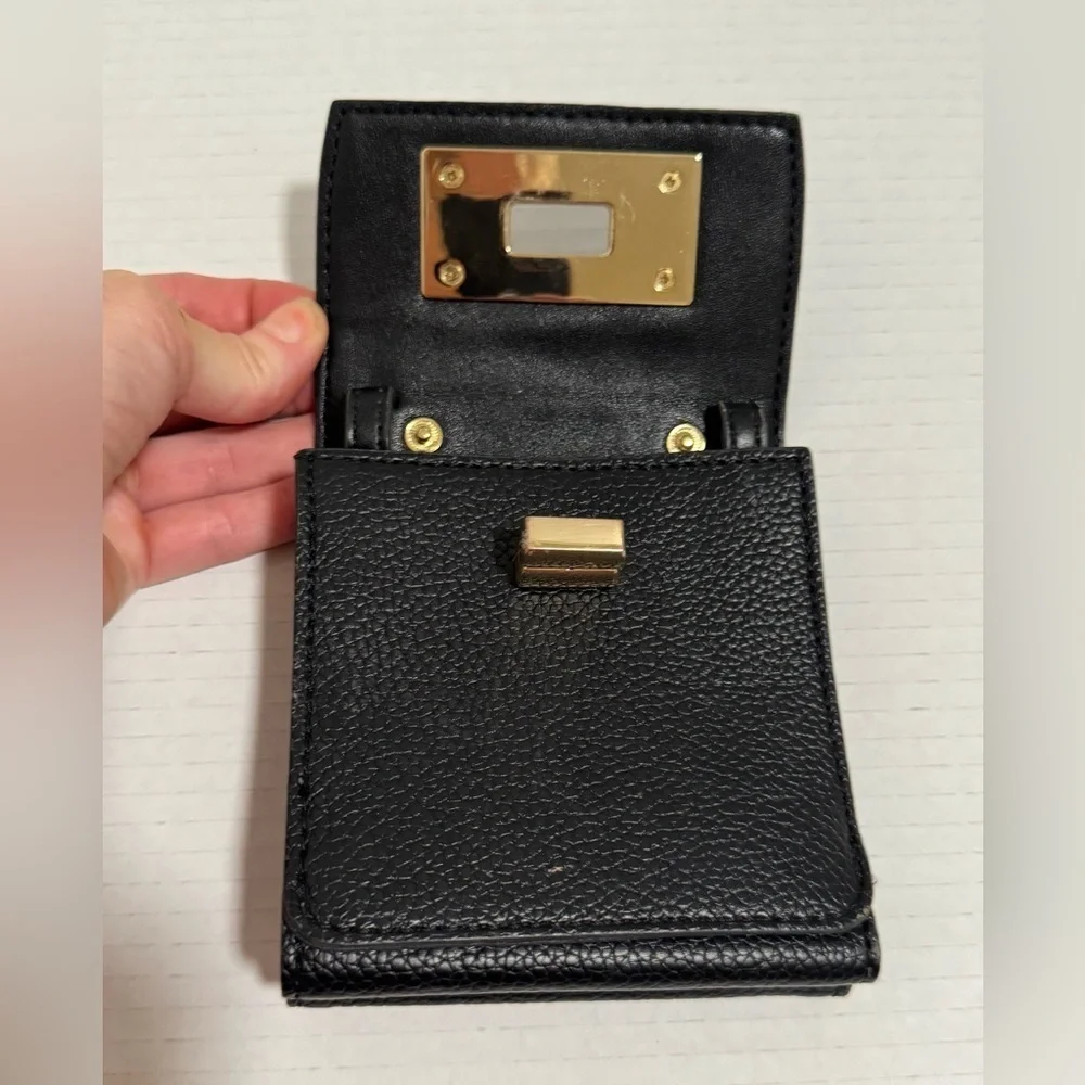 Calvin Klein black trifold wallet with a gold-tone metal closure